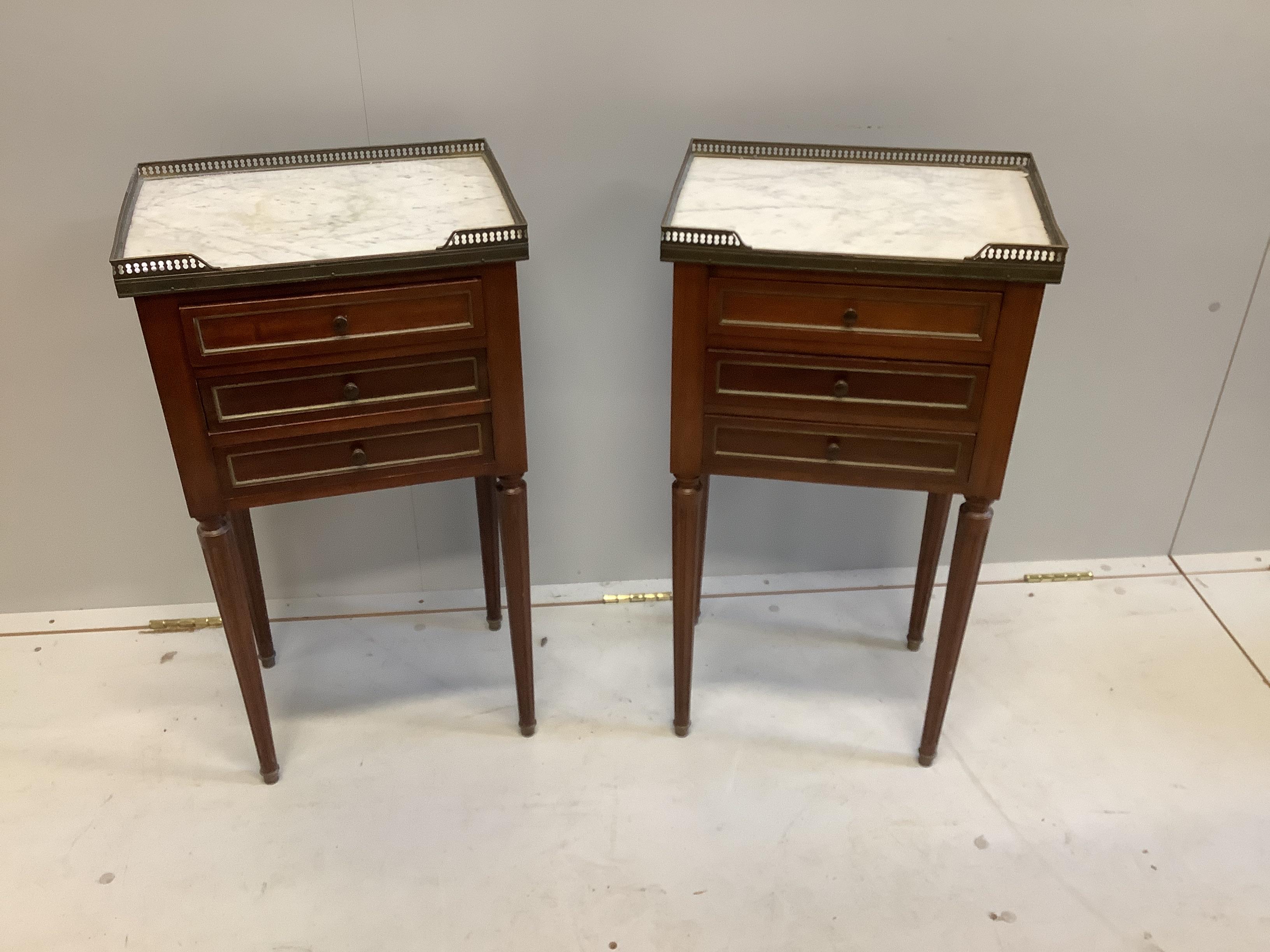 A pair of French brass mounted marble topped mahogany three drawer bedside chests, width 39cm, depth 28cm, height 73cm